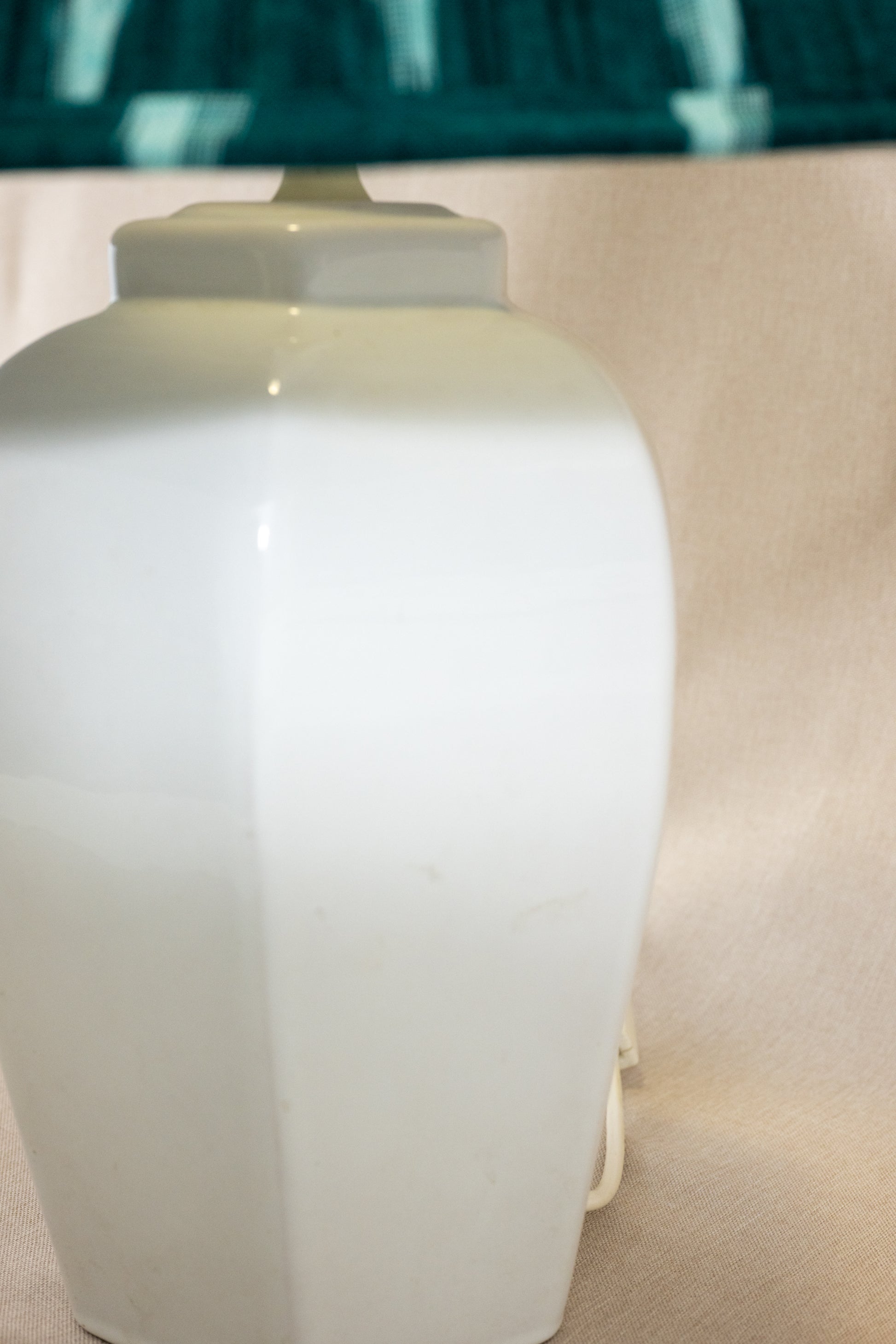 Table lamp with white hexagonal ceramic base and green shade Side view