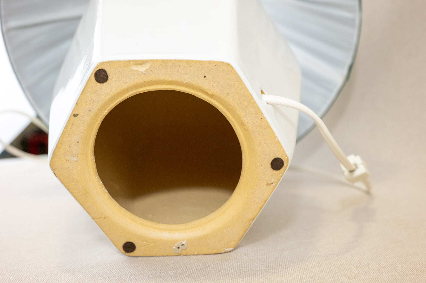 Table lamp with white hexagonal ceramic base and green shade Bottom view