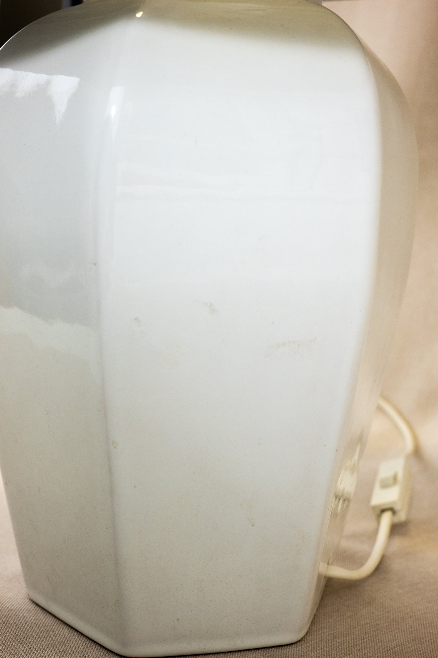 Table lamp with white hexagonal ceramic base and green shade Side view