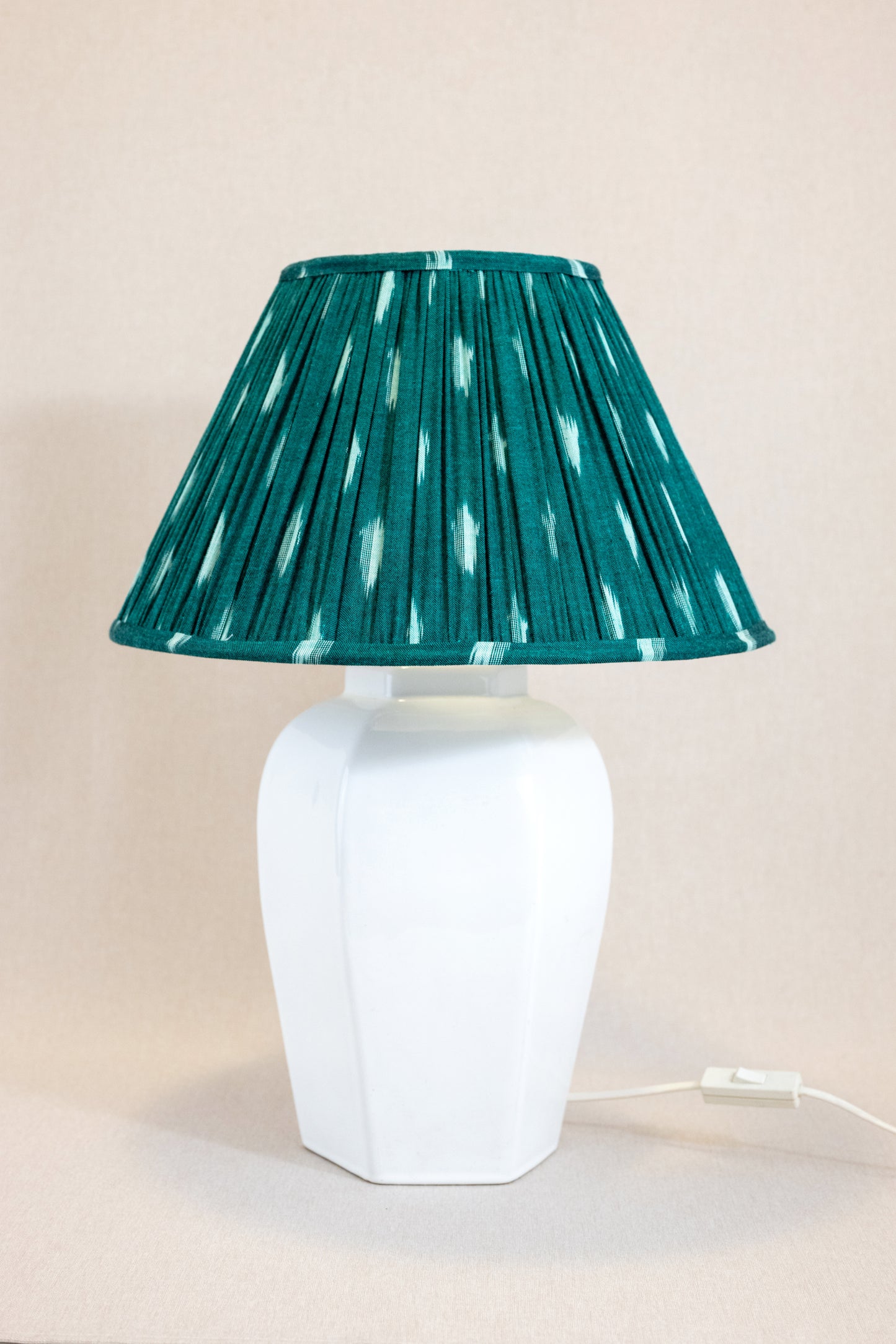 Table lamp with white hexagonal ceramic base with green shade