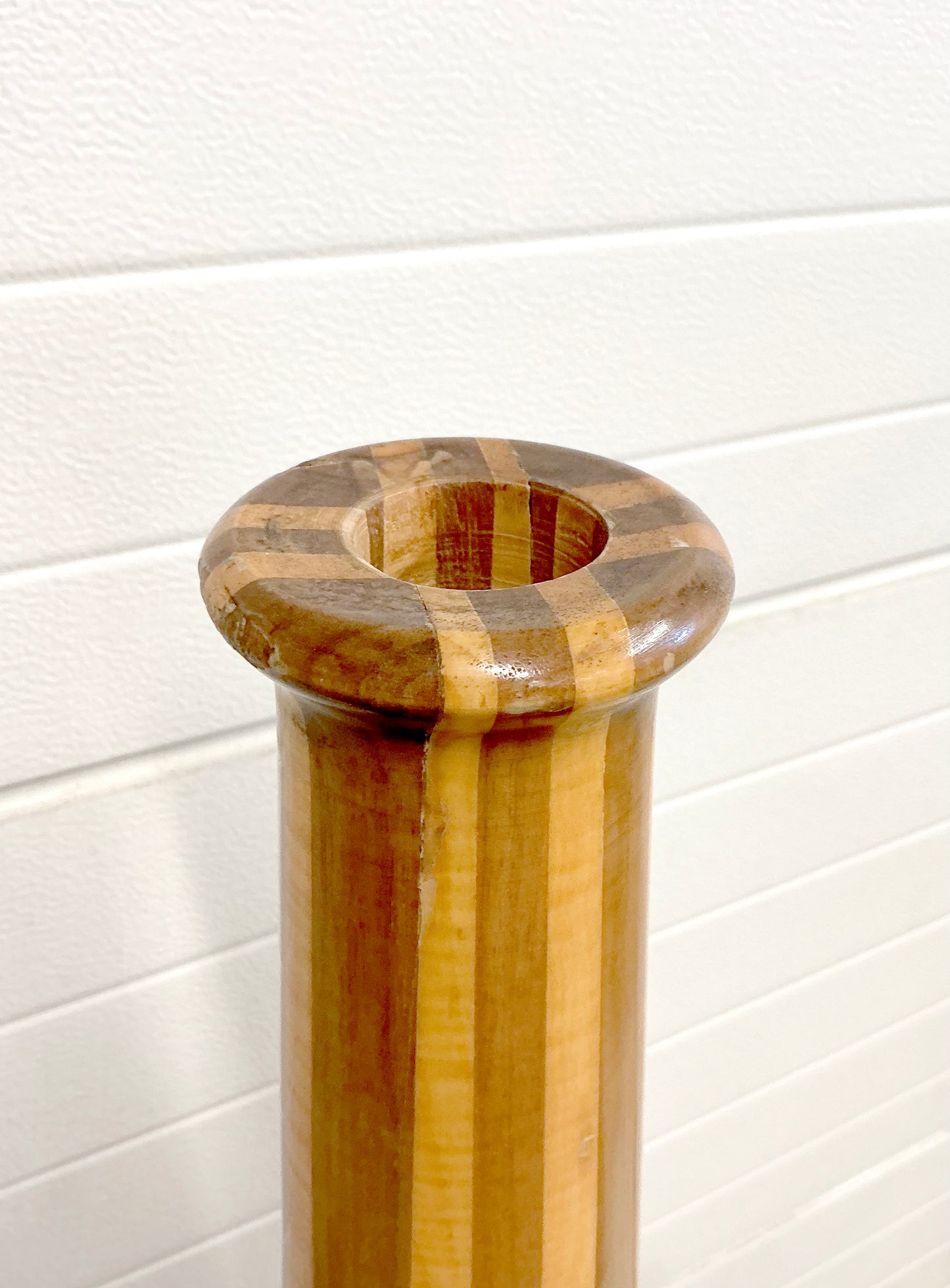 Tall vintage wood vase stand mid century in front of garage doors