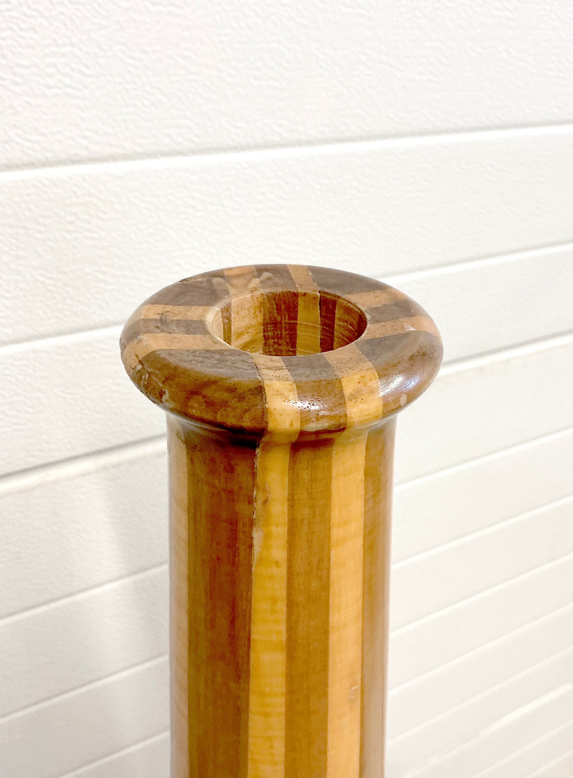 Tall vintage wood vase stand mid century in front of garage doors